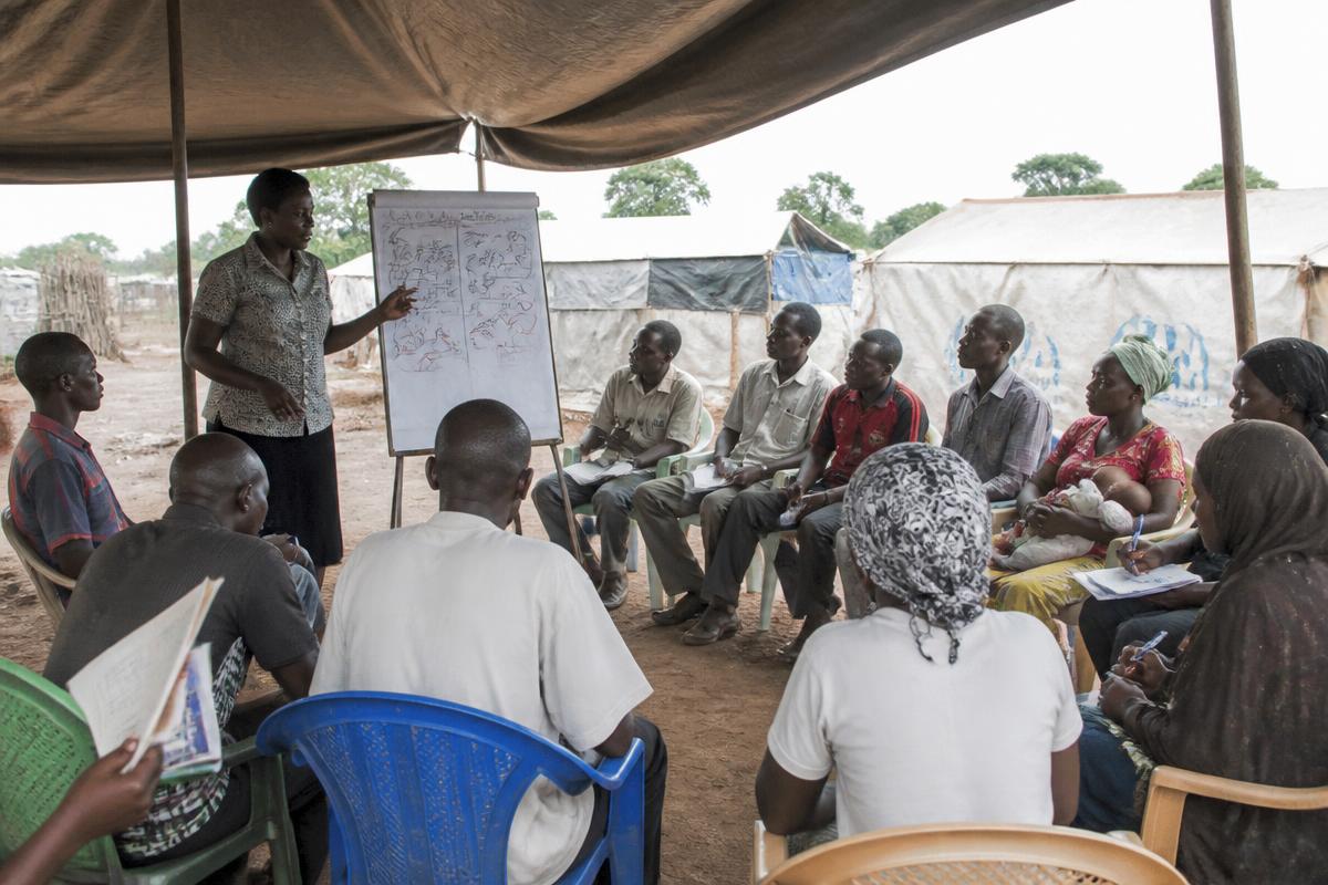 Adults attending a health and protection training session with a trainer at a community centre